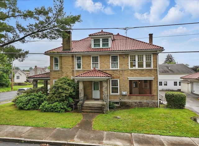 639 Iron St, Lehighton, PA 18235 - view of front of property with a chimney, a tile roof, a front lawn, and brick siding