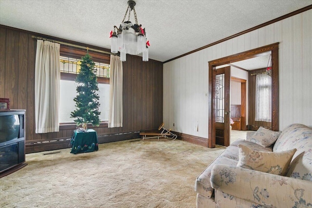 639 Iron St, Lehighton, PA 18235 - living room with crown molding, a textured ceiling, carpet, and wood walls