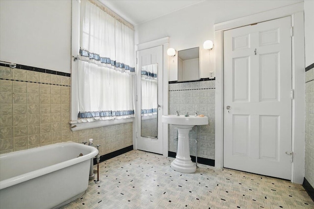 639 Iron St, Lehighton, PA 18235 - full bath with tile walls, a freestanding bath, tile patterned floors, and wainscoting