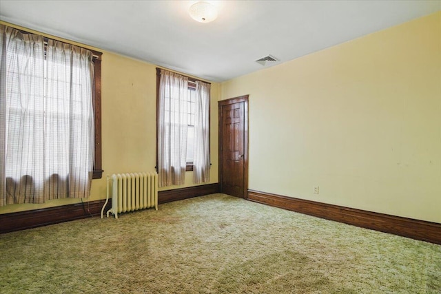 639 Iron St, Lehighton, PA 18235 - empty room with radiator, carpet flooring, and plenty of natural light