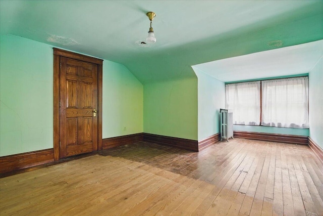 639 Iron St, Lehighton, PA 18235 - additional living space featuring wood-type flooring, vaulted ceiling, and radiator heating unit
