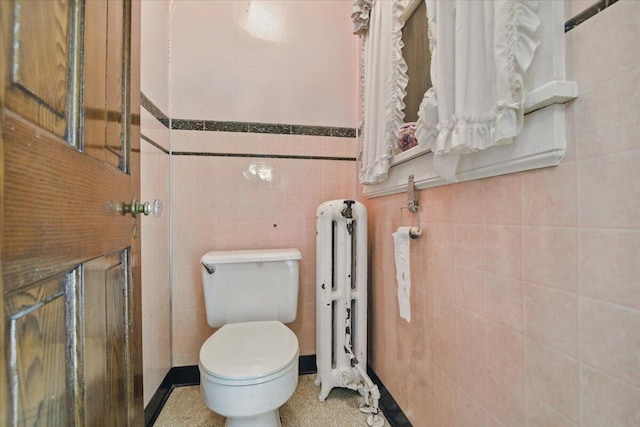 639 Iron St, Lehighton, PA 18235 - bathroom with radiator heating unit, tile walls, and a wainscoted wall