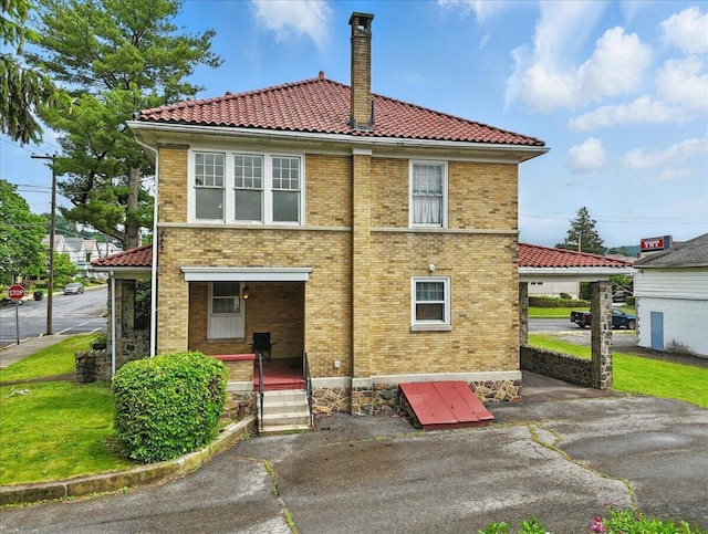 639 Iron St, Lehighton, PA 18235 - rear view of house featuring a tiled roof, brick siding, and a chimney