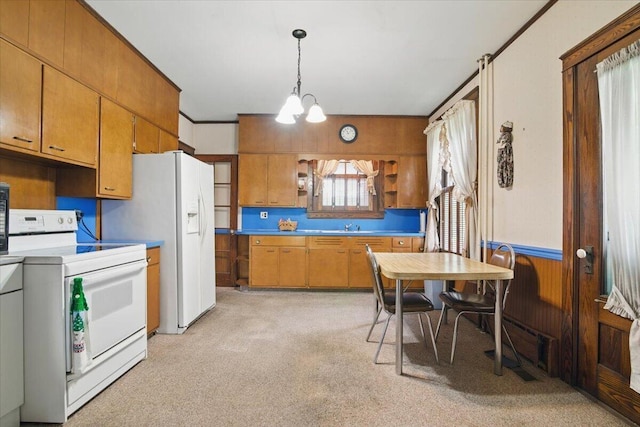639 Iron St, Lehighton, PA 18235 - kitchen featuring white appliances, light colored carpet, a chandelier, brown cabinets, and hanging light fixtures