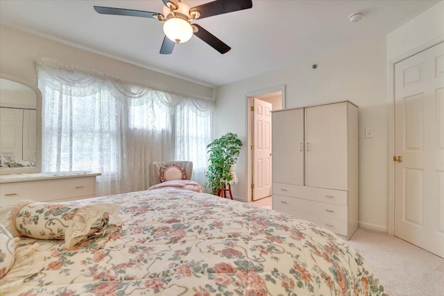 bedroom featuring carpet flooring, a ceiling fan, and arched walkways