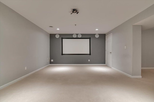cinema room with baseboards, recessed lighting, and light colored carpet