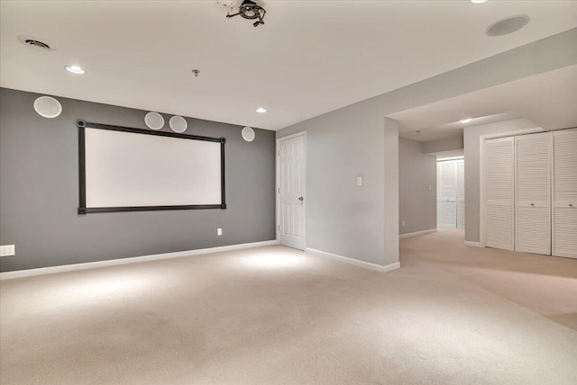 spare room featuring light colored carpet, recessed lighting, baseboards, and visible vents