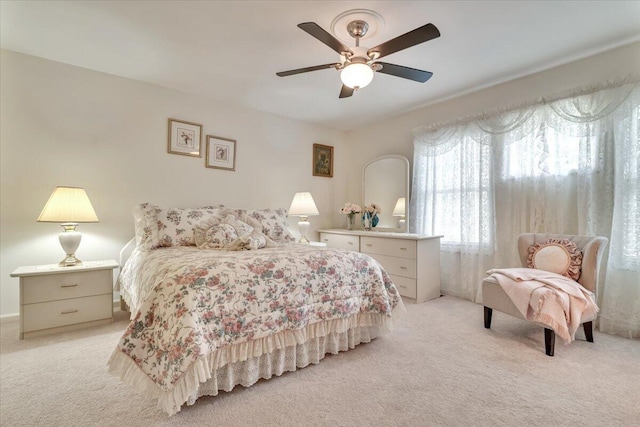 bedroom with light colored carpet and ceiling fan