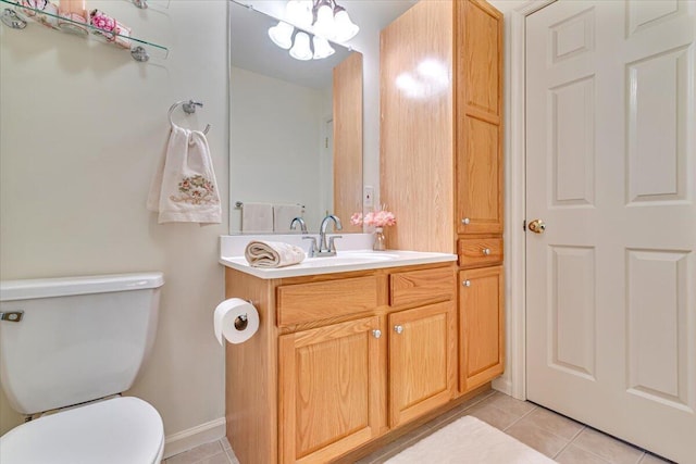 half bathroom featuring vanity, an inviting chandelier, toilet, baseboards, and tile patterned floors