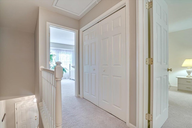 hall with carpet and an upstairs landing