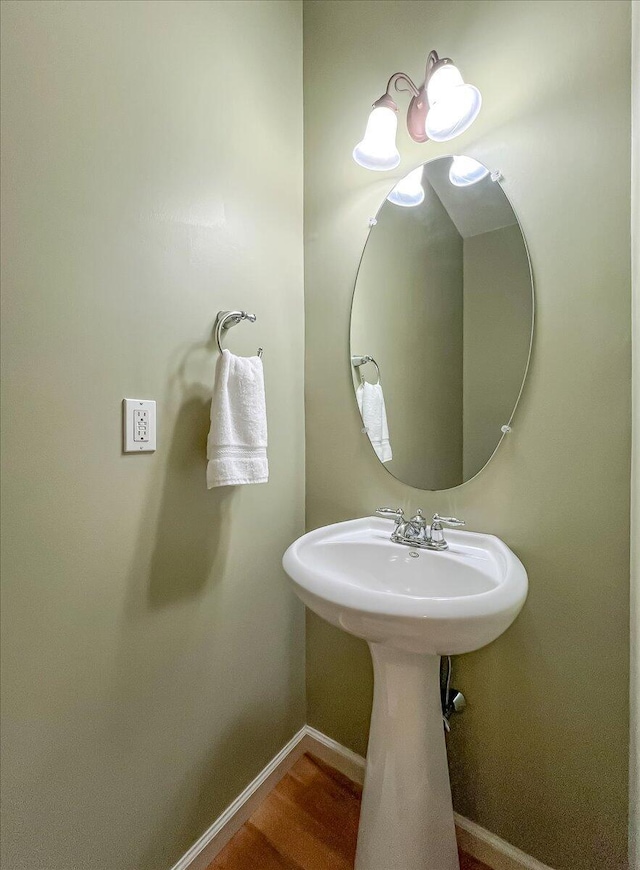 bathroom with baseboards and wood finished floors