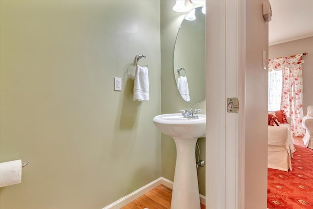 bathroom featuring baseboards and wood finished floors