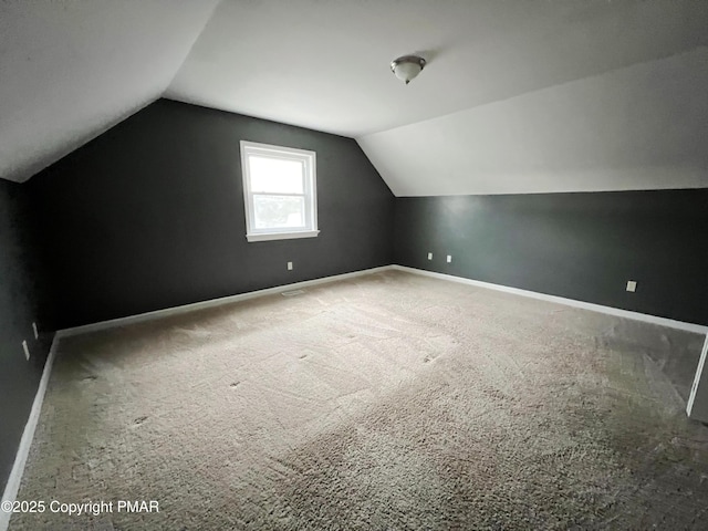 bonus room featuring carpet floors, vaulted ceiling, and baseboards