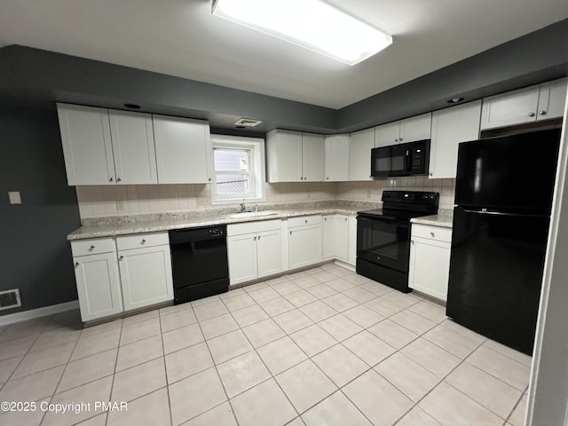 kitchen with decorative backsplash, white cabinets, a sink, and black appliances