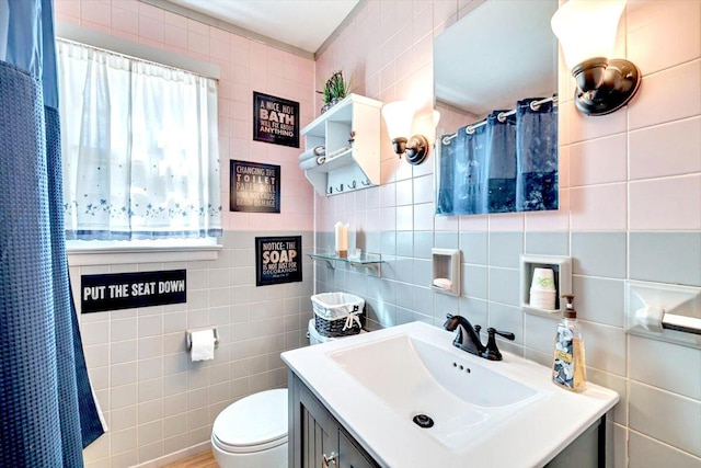 bathroom featuring a shower with shower curtain, toilet, tile walls, and vanity