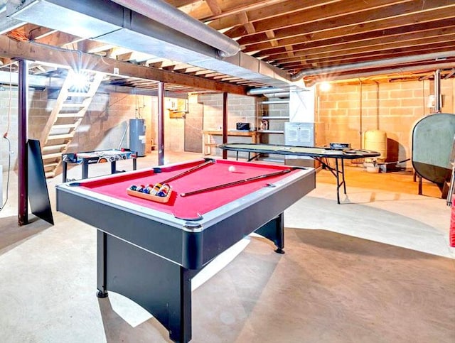 playroom featuring water heater, heating fuel, concrete flooring, and billiards