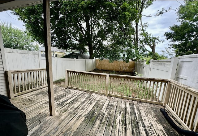 wooden terrace featuring a fenced backyard