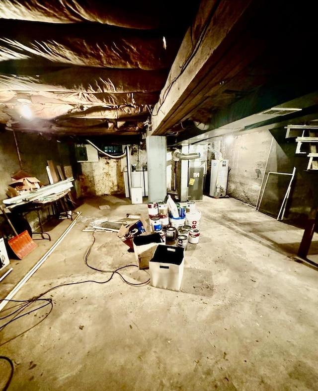 unfinished basement featuring gas water heater