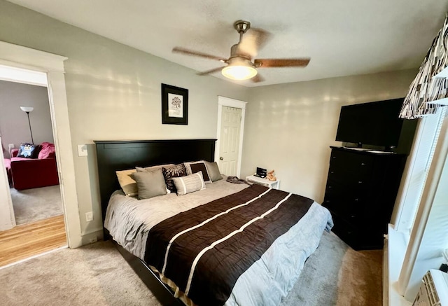 bedroom featuring ceiling fan and light carpet