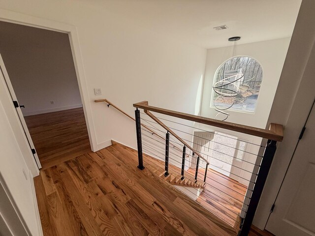 unfurnished bedroom with recessed lighting, a closet, baseboards, and wood finished floors