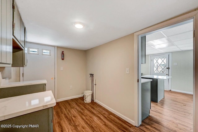 washroom with baseboards and wood finished floors