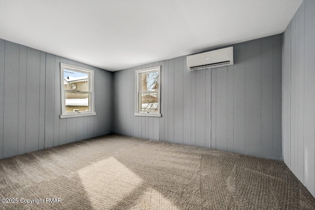 carpeted spare room with an AC wall unit