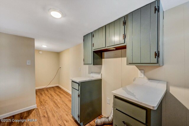 kitchen featuring light countertops, baseboards, and light wood finished floors