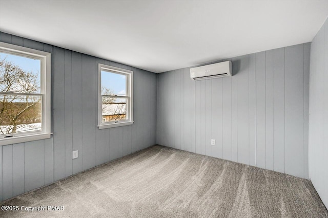 unfurnished room featuring an AC wall unit and carpet flooring