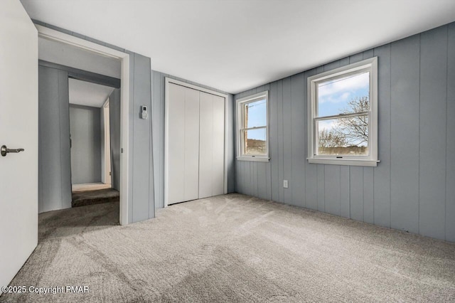 unfurnished bedroom featuring a closet and carpet