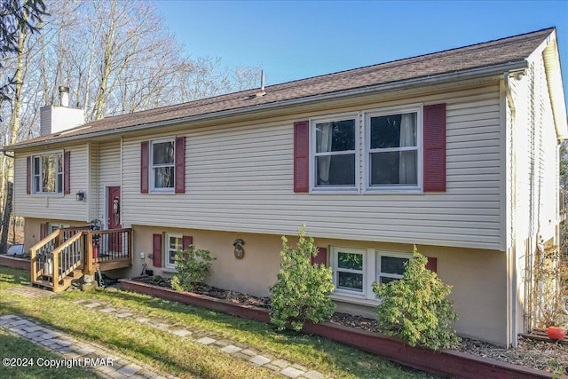 view of front of house featuring stucco siding and a chimney