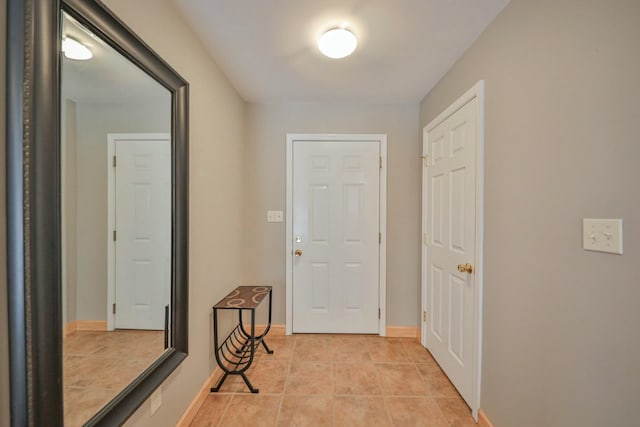 interior space with light tile patterned flooring and baseboards