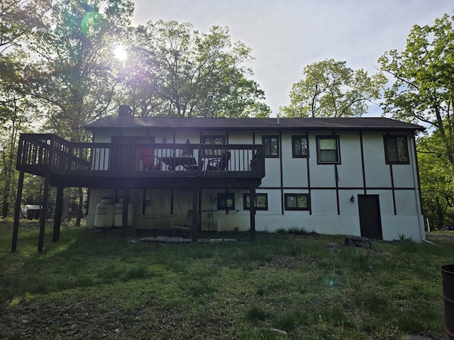 234 Saturn Dr, Bushkill, PA 18324 - back of house with a deck, a lawn, a chimney, and stucco siding