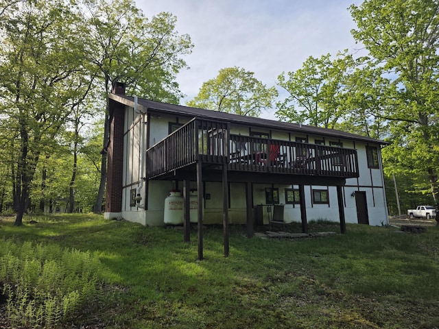 234 Saturn Dr, Bushkill, PA 18324 - back of house with a chimney, a wooden deck, and a yard