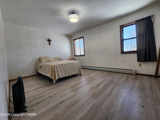 234 Saturn Dr, Bushkill, PA 18324 - bedroom featuring wood finished floors, multiple windows, and baseboard heating