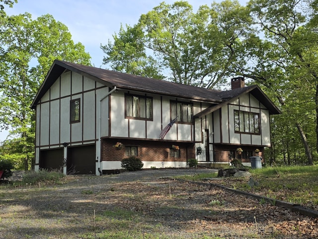 234 Saturn Dr, Bushkill, PA 18324 - view of front of home with a chimney, board and batten siding, and brick siding