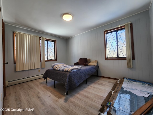 234 Saturn Dr, Bushkill, PA 18324 - bedroom with a baseboard heating unit, multiple windows, wood finished floors, and crown molding