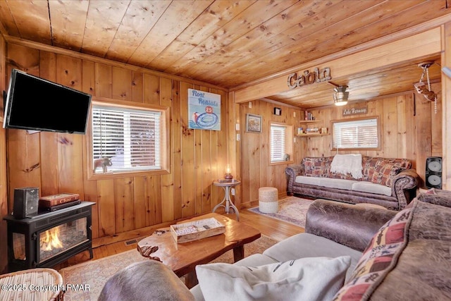 living room featuring wood walls, light hardwood / wood-style flooring, and wooden ceiling