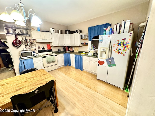 kitchen featuring white appliances, dark countertops, white cabinetry, and light wood-style floors