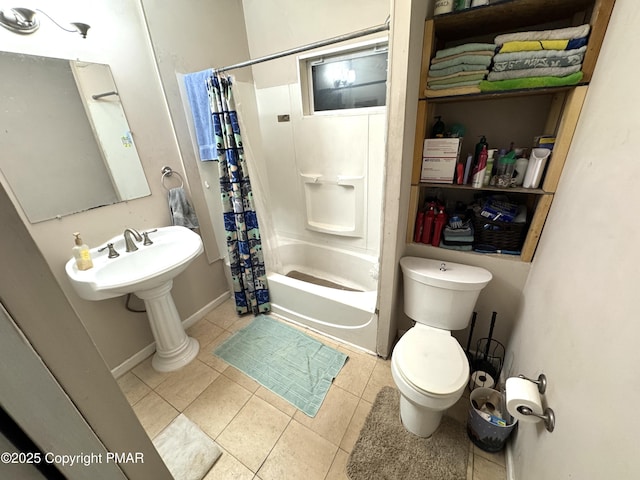 bathroom with tile patterned flooring, toilet, a sink, baseboards, and shower / bathtub combination with curtain