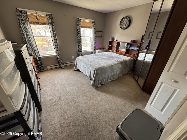 carpeted bedroom with a baseboard radiator and baseboards