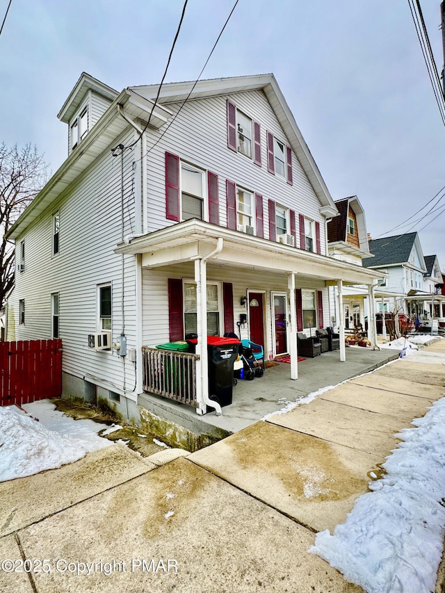 view of property with fence and a porch