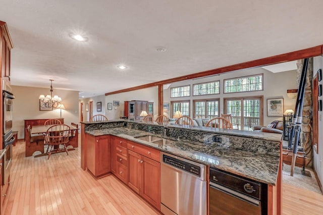 3110 Tall Timber Lake Rd, Pocono Pines, PA 18350 - kitchen with dishwasher, a sink, a chandelier, open floor plan, and light wood-type flooring