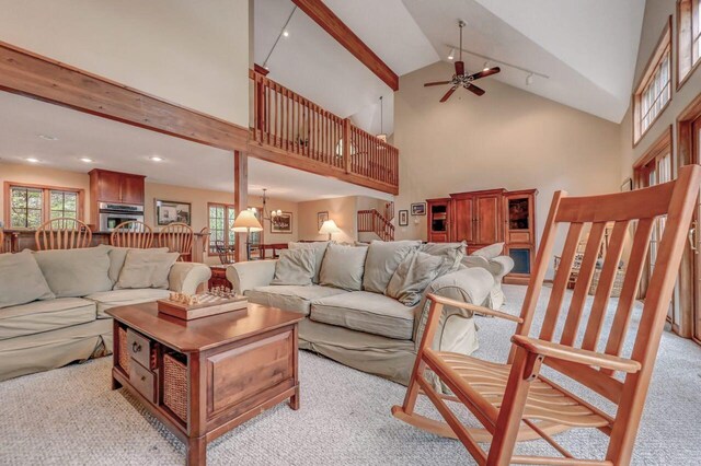 3110 Tall Timber Lake Rd, Pocono Pines, PA 18350 - living room with light carpet, a ceiling fan, stairway, and high vaulted ceiling
