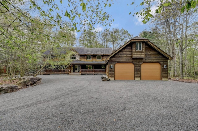 3110 Tall Timber Lake Rd, Pocono Pines, PA 18350 - view of front of house featuring a porch, a garage, and asphalt driveway