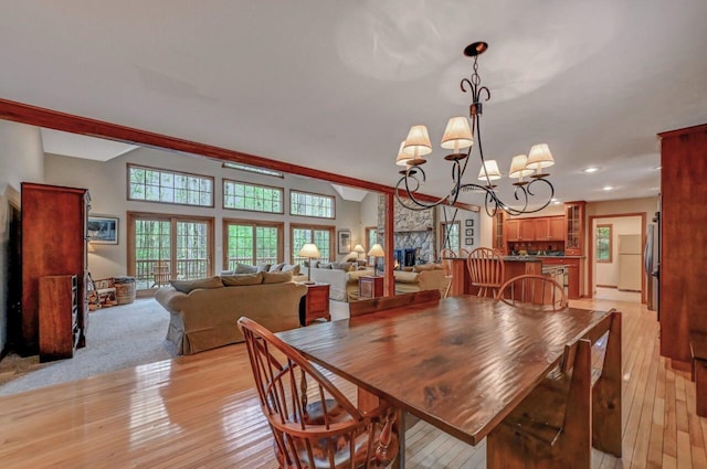 3110 Tall Timber Lake Rd, Pocono Pines, PA 18350 - dining room with light wood-type flooring, a chandelier, a fireplace, and recessed lighting