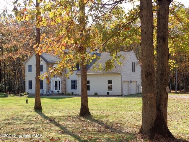 view of front of home featuring a garage, roof with shingles, a front lawn, and french doors