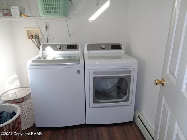 washroom featuring laundry area, a baseboard radiator, dark wood finished floors, and washing machine and clothes dryer