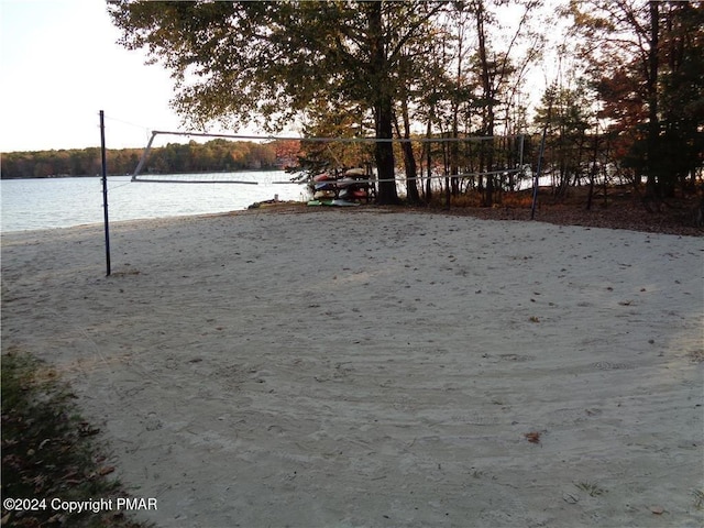 view of yard with a water view and volleyball court