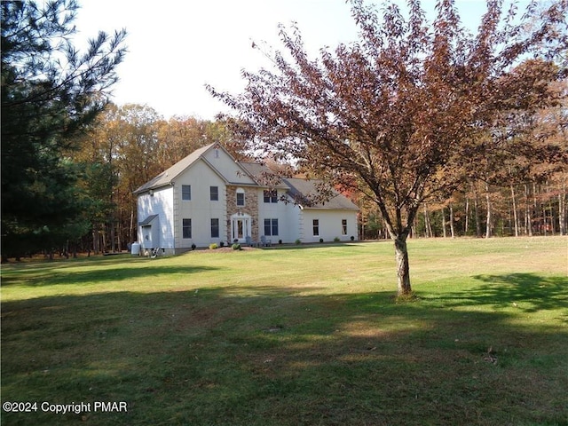 back of property featuring a lawn