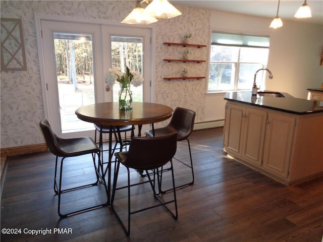 dining area featuring dark wood-style floors, baseboards, baseboard heating, and wallpapered walls